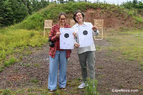 gun club members with paper targets